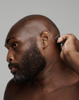 black man shaving his head with frederick benjamin shaving products