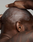 black man shaving his head with frederick benjamin shaving products