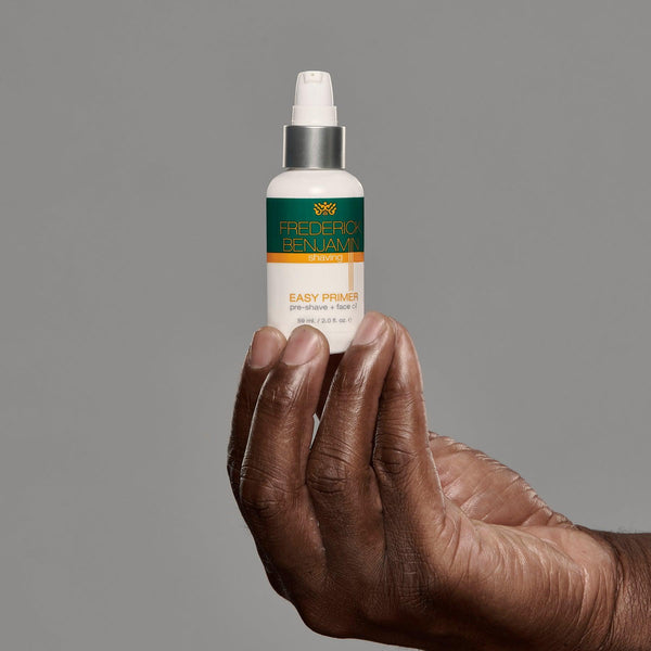 black man holding frederick benjamin easy primer, best pre shave product for black men, best product for pain free shaving, best product for men of color to prevent razor bumps